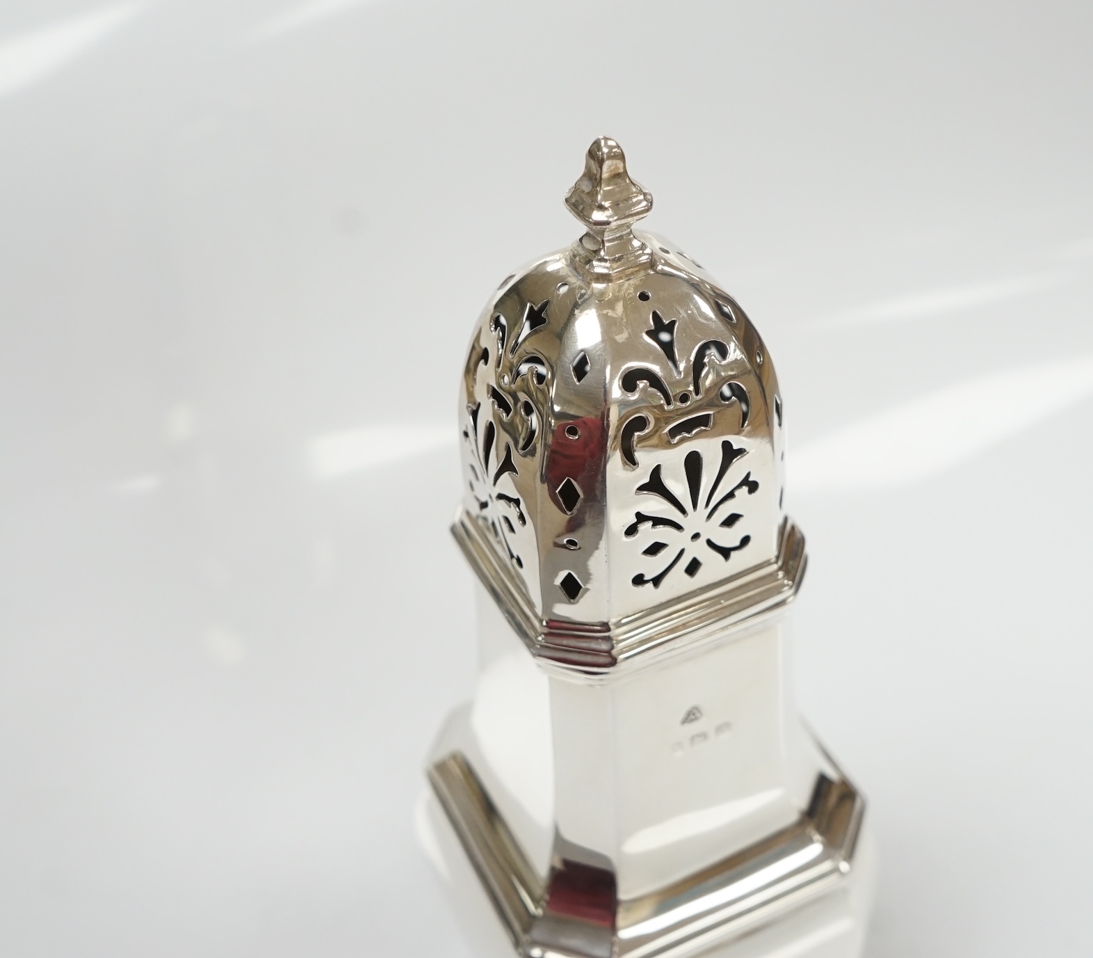 A George V silver octagonal baluster sugar castor, by Adie Bros, height 18.3cm, 5.3oz. Condition - poor